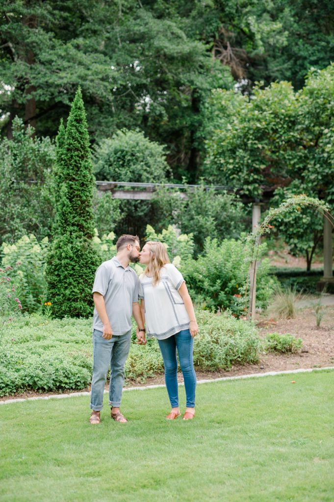 engaged couple kissing  at cator wooldford gardens