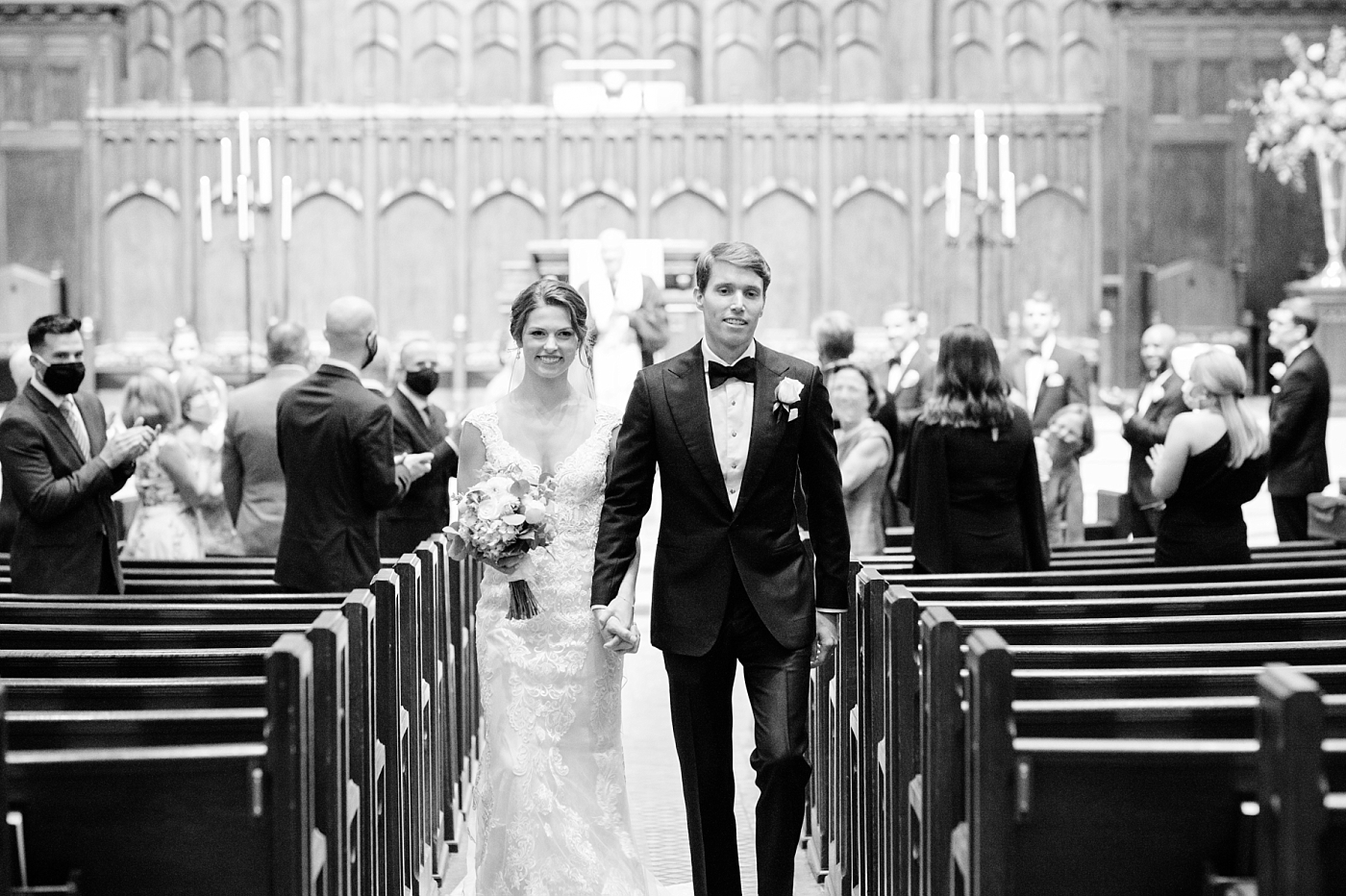 bride and groom walking down the aisle after their wedding ceremony