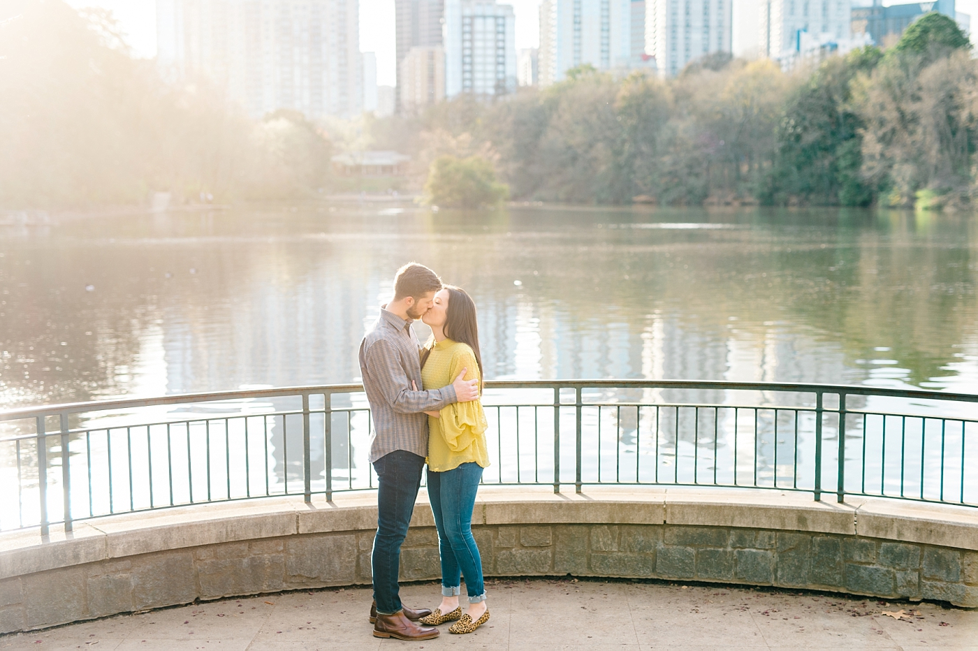 engaged couple kissing at engagement session in piedmont park