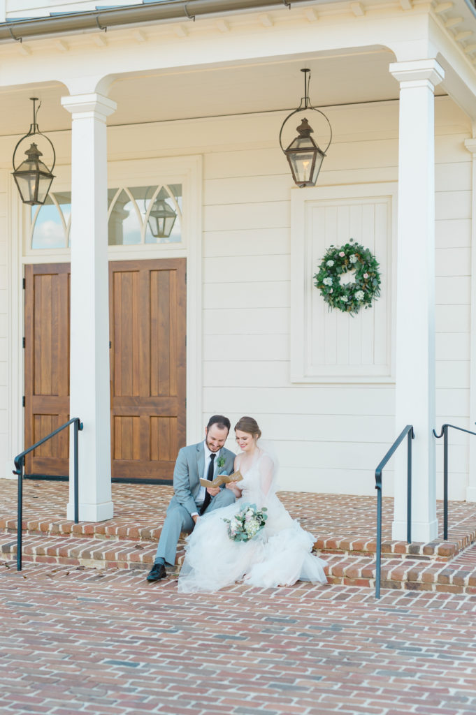 bride and groom sitting outside reading vows wedding old town columbus ga