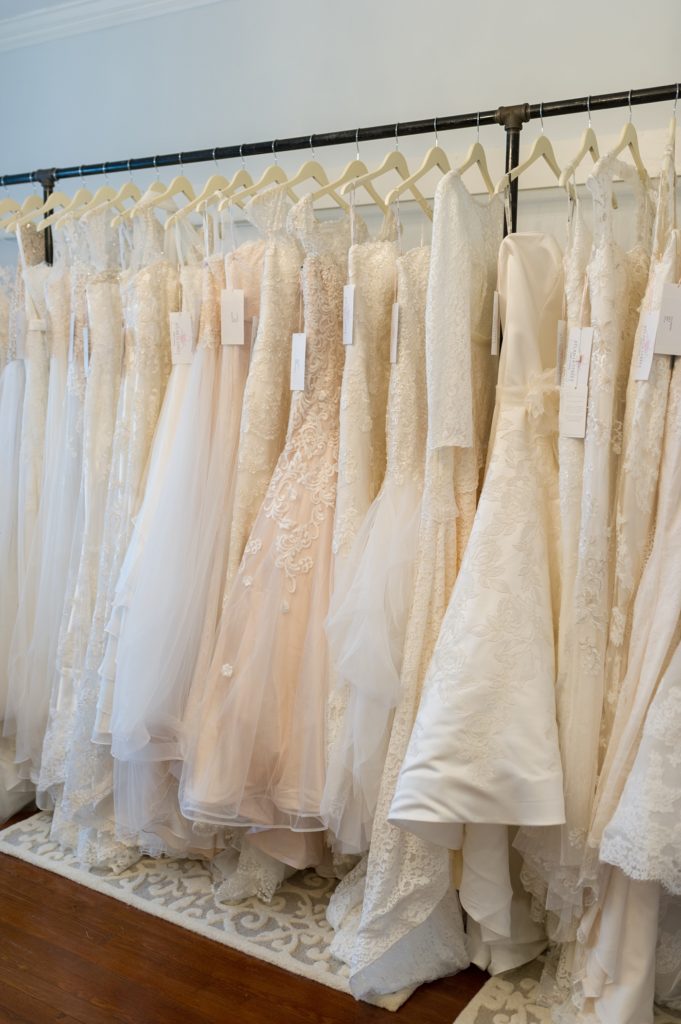wedding dresses hanging up at a bridal dress shop